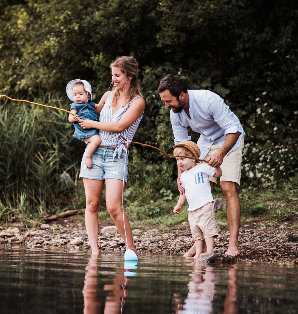 family fishing in river